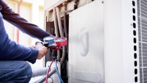 Technician is checking air conditioner ,measuring equipment for filling air conditioners.